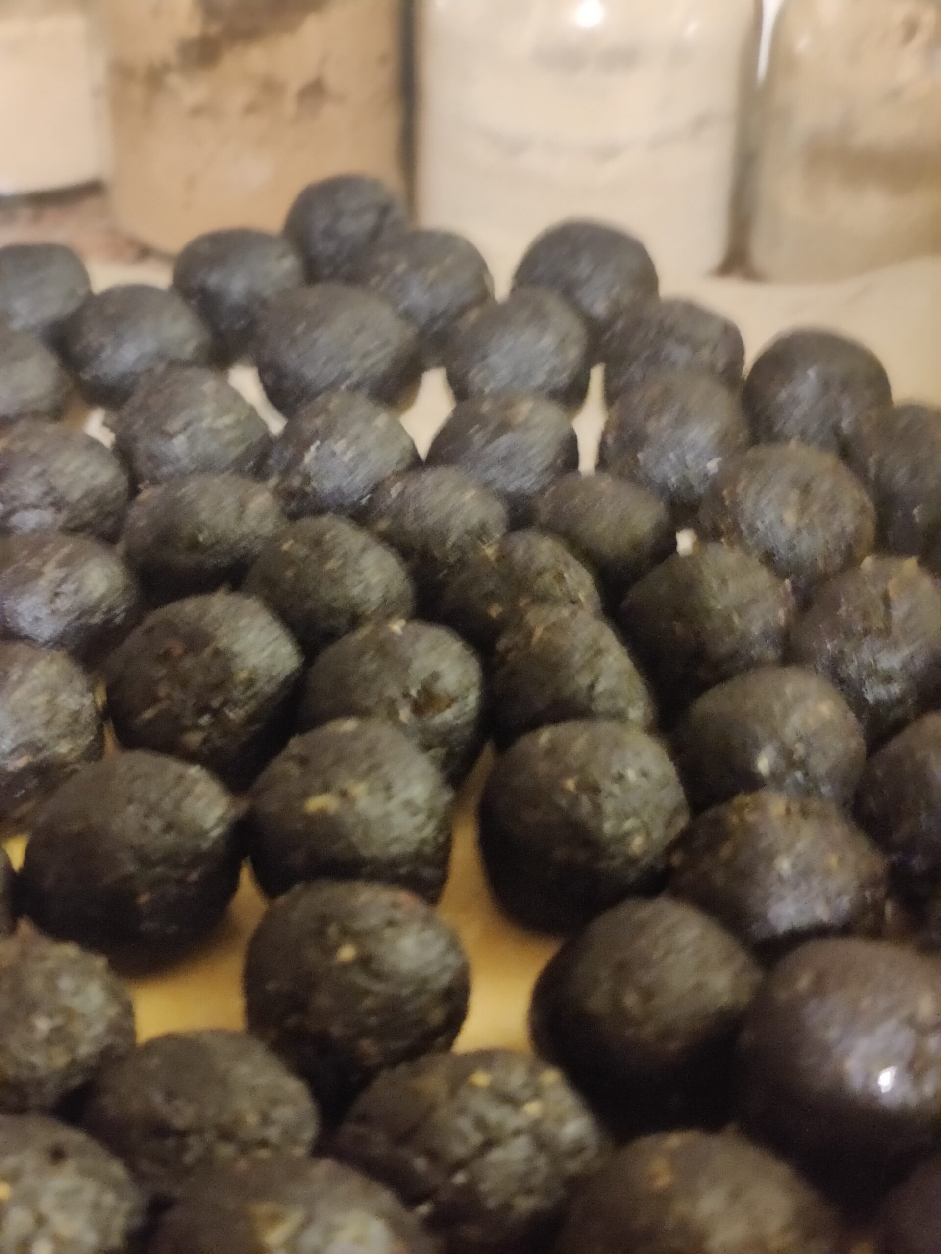 A pile of chocolate balls sitting on top of a table.